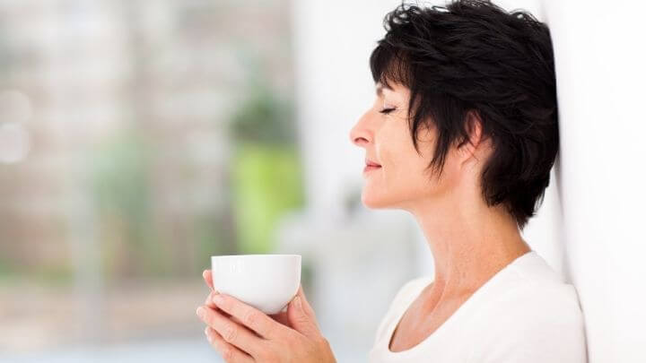Middle aged woman enjoying a cup of tea